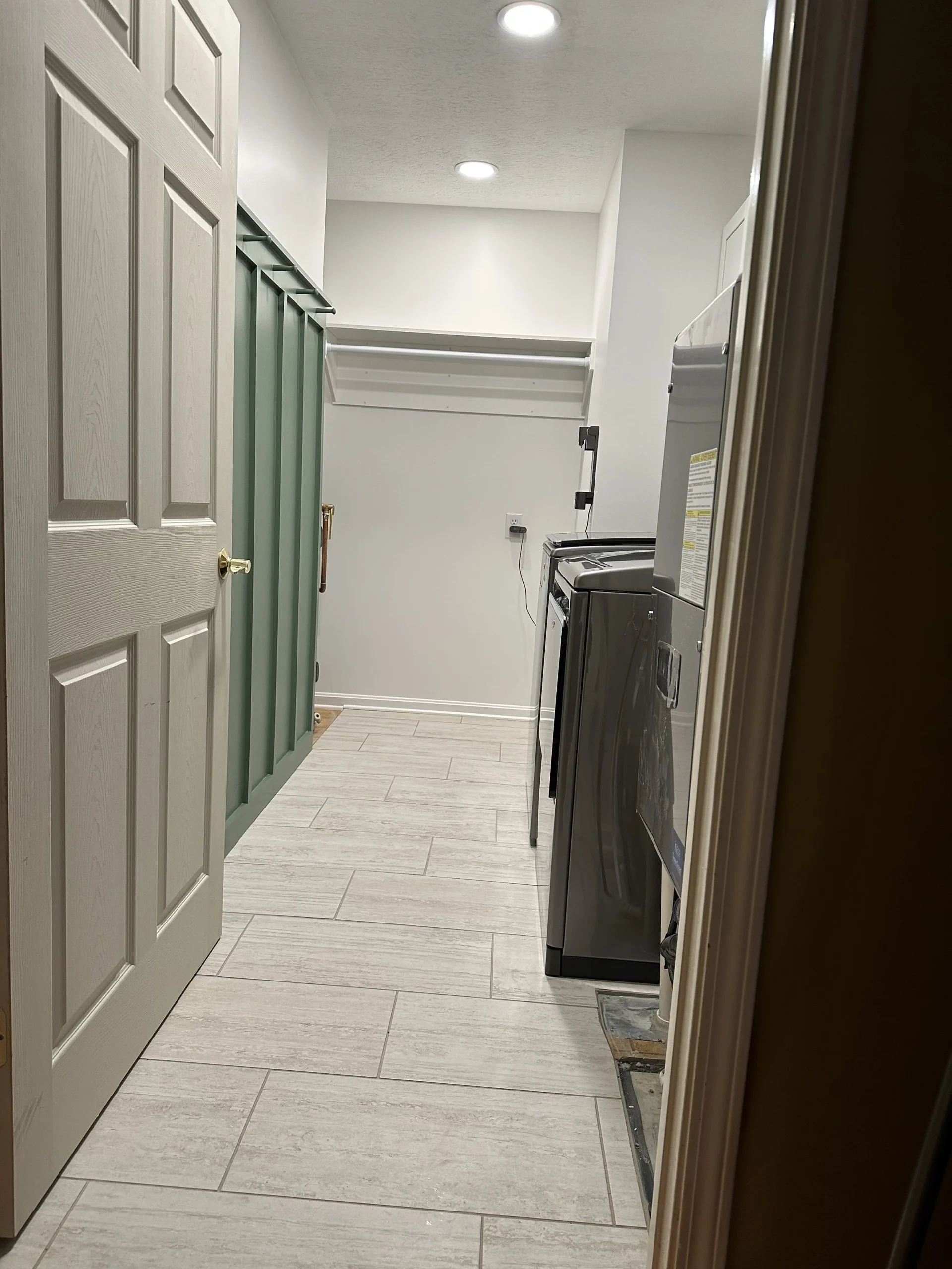 Mudroom with sage green cabinetry