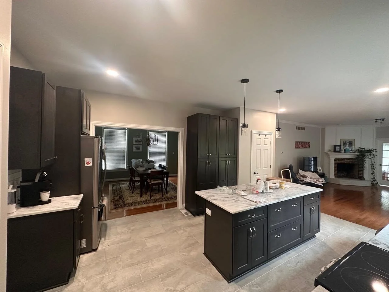 Kitchen with dark island and stone countertops