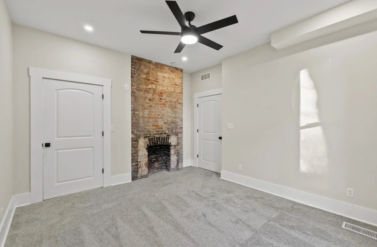Finished room with brick accent and new carpet