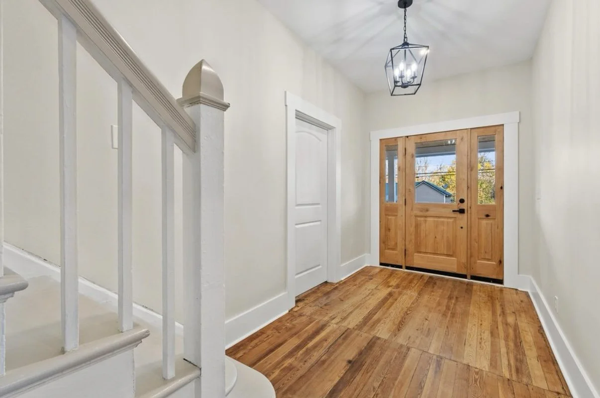 Entry with wood front door and hardwood floors
