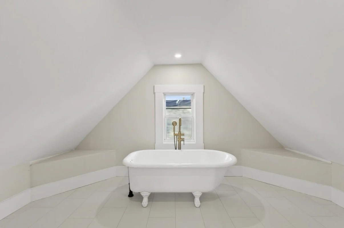 Attic bathroom with freestanding clawfoot tub