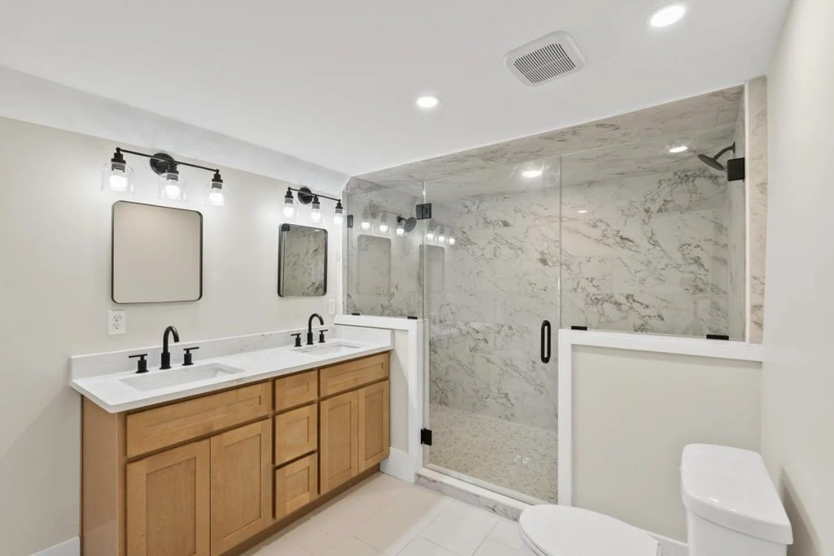 Bathroom with wood vanity and glass shower