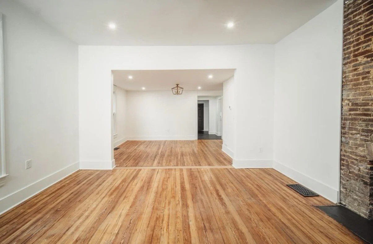 Renovated room with cased opening and hardwood floors