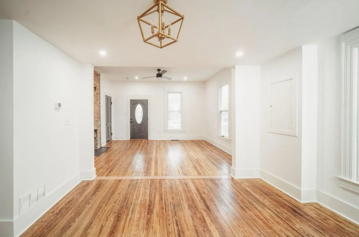 Entry hall with hardwood floors and pendant light