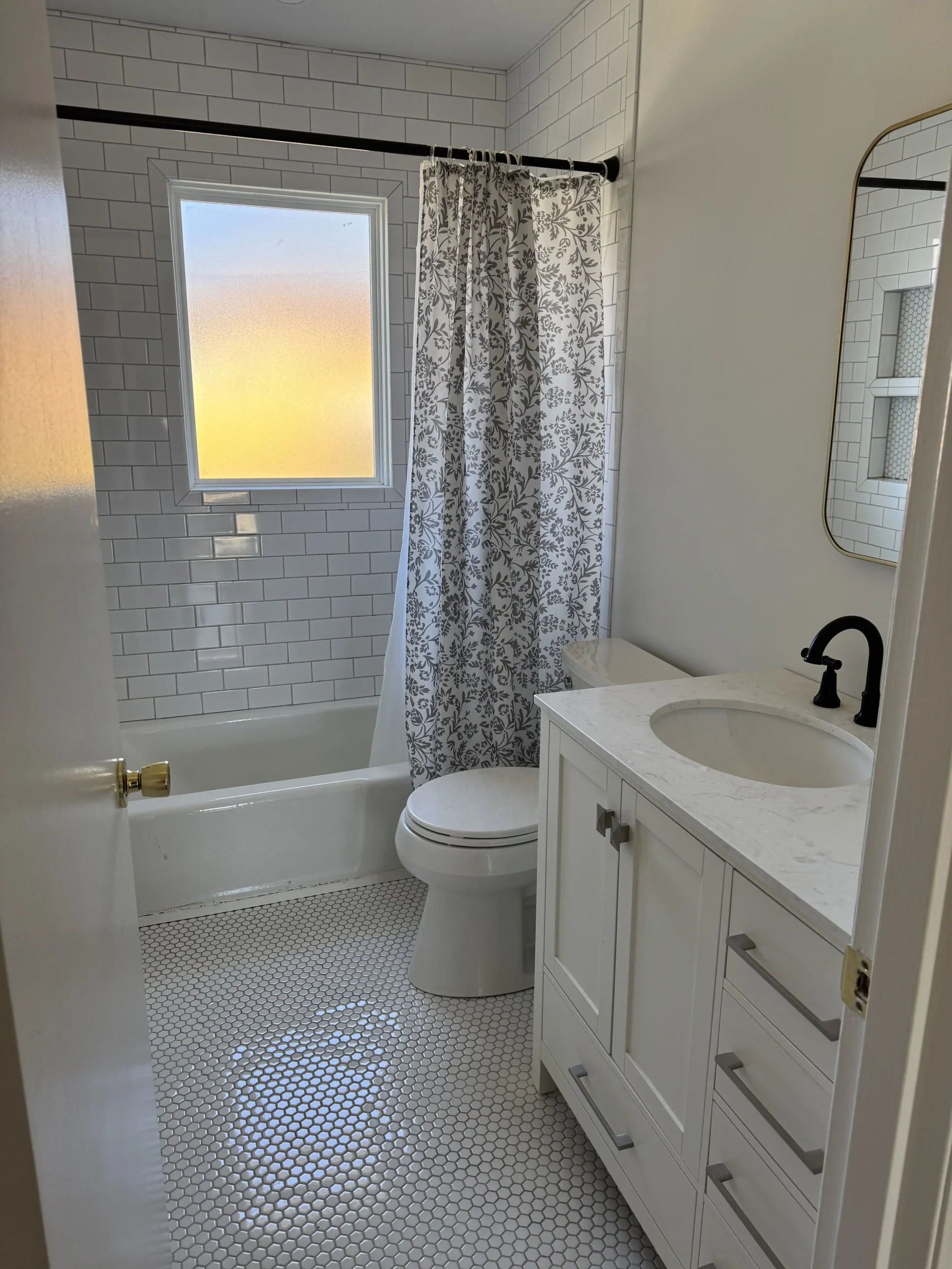 Bathroom with window and tiled tub