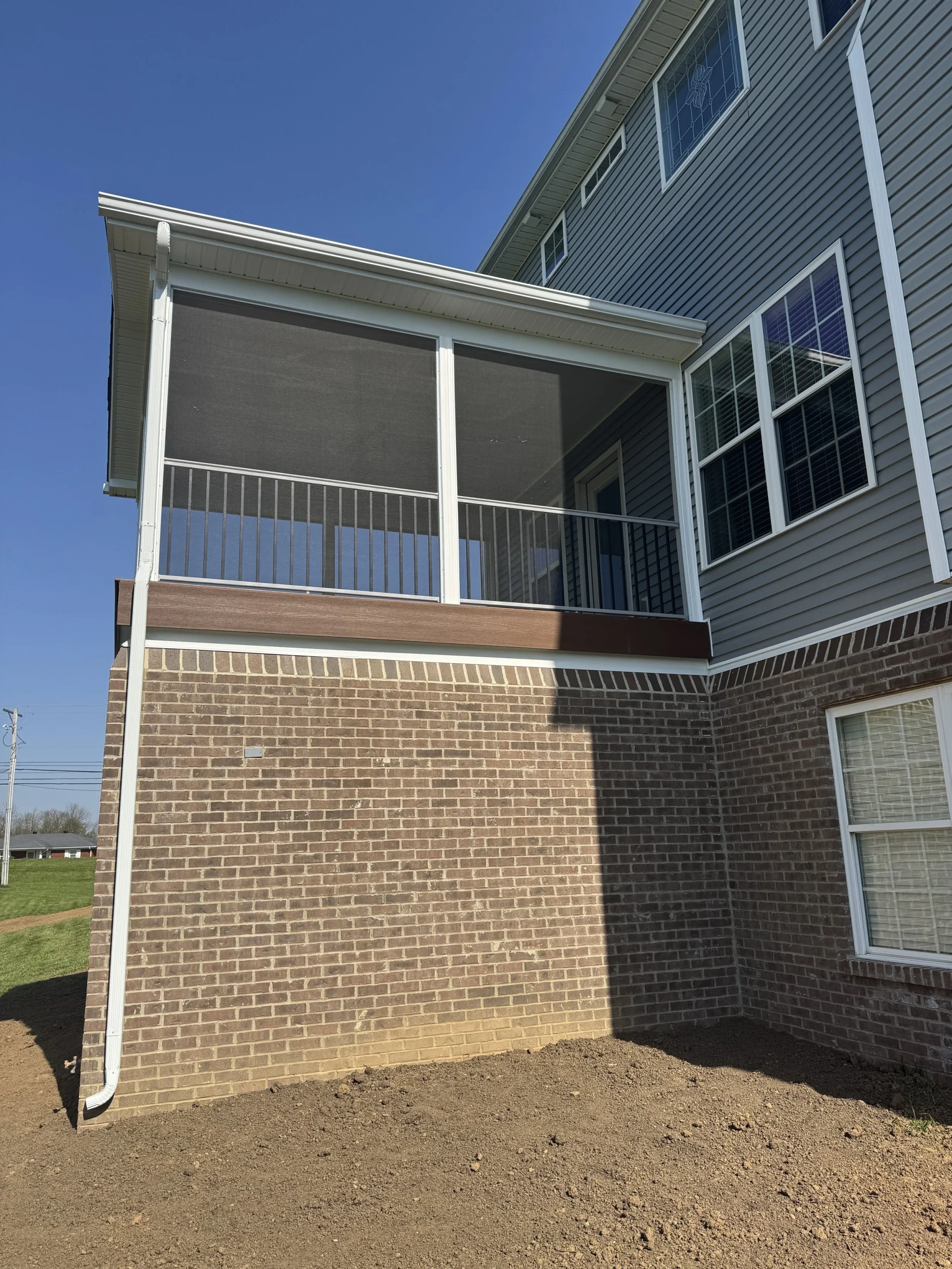 Screened porch addition on brick foundation