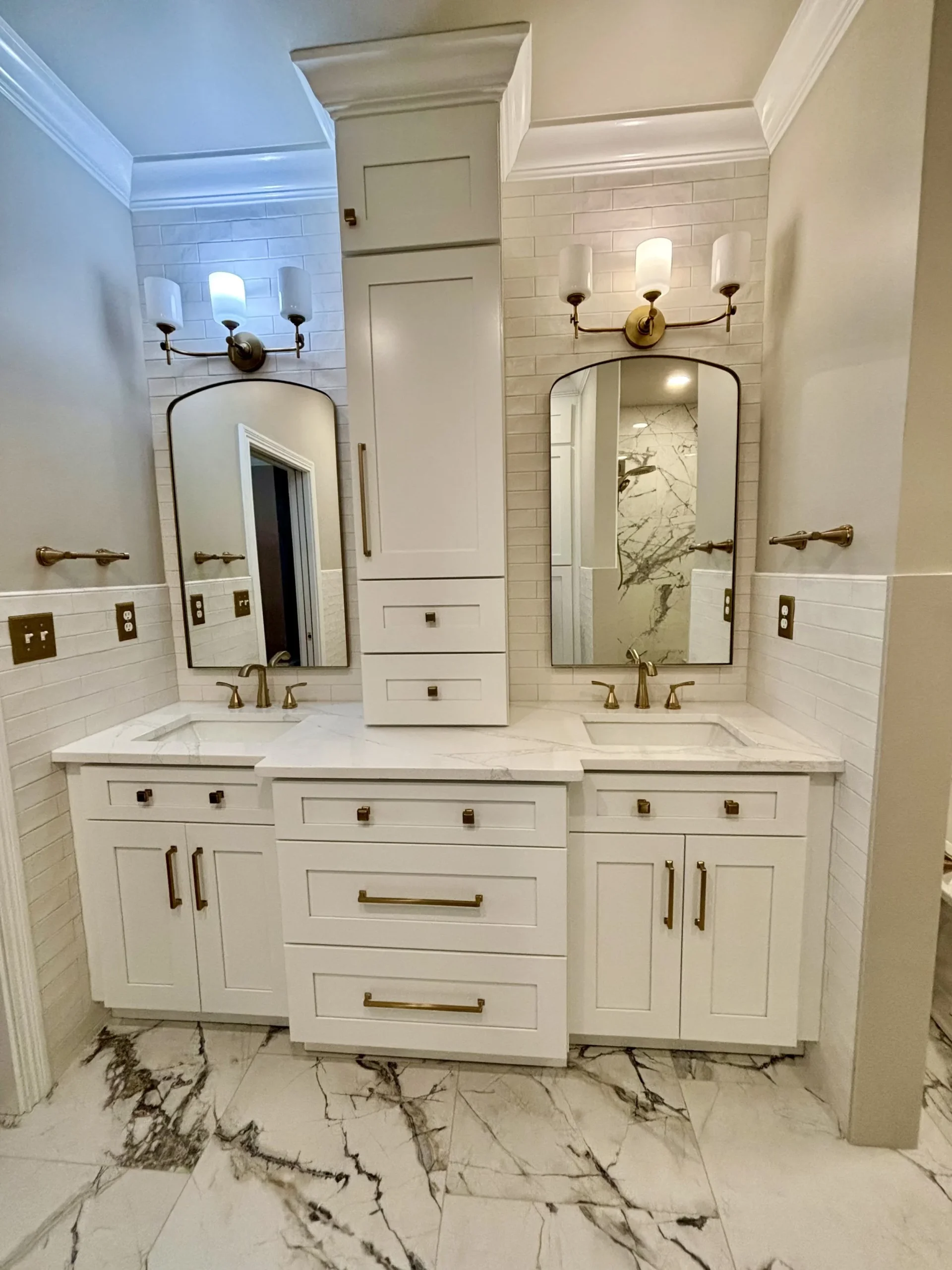 Bathroom with double vanity and brass fixtures